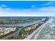 An aerial view displays both the ocean and the inter-coastal waterway in this lovely community at 645 Palmetto Dr, Venice, FL 34293