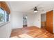 Bright bedroom with light colored walls, wood floor, and a view to an upper floor at 645 Palmetto Dr, Venice, FL 34293