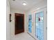 Entryway featuring a classic wooden door and a stylish stained-glass double door that leads to the inside of the home at 645 Palmetto Dr, Venice, FL 34293