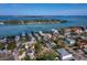 Beautiful aerial view of waterfront homes and a tranquil bay under a clear blue sky at 7119 Longboat E Dr, Longboat Key, FL 34228