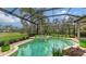 View of the enclosed pool and patio with landscaping at 7849 Wilton Crescent Cir, University Park, FL 34201