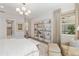 Bright bedroom with a seating area, view to the outside and neutral color palette at 8077 Tidal Pointe Way, Sarasota, FL 34240