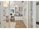 An organized home office with custom built-in shelving and a neutral color palette at 8077 Tidal Pointe Way, Sarasota, FL 34240