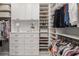 Organized walk-in closet with shelving, drawers, and ample space for clothing and accessories at 8077 Tidal Pointe Way, Sarasota, FL 34240