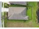 An aerial view of a well-maintained single-Gathering home with a brown roof, a fenced backyard and lush green lawn at 815 Rosemary Cir, Bradenton, FL 34212