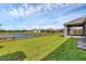Spacious backyard with green grass, a black fence, and beautiful water views at 815 Rosemary Cir, Bradenton, FL 34212