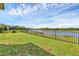 Backyard with a black fence and beautiful water views for privacy at 815 Rosemary Cir, Bradenton, FL 34212