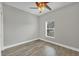 Bright bedroom with a ceiling fan, window and light gray wood-look flooring at 815 Rosemary Cir, Bradenton, FL 34212