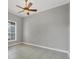 Bedroom with light colored tile flooring, a ceiling fan and a window with blinds at 815 Rosemary Cir, Bradenton, FL 34212