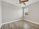Bright bedroom with a ceiling fan, window and light gray wood-look flooring at 815 Rosemary Cir, Bradenton, FL 34212