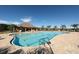 Expansive community pool surrounded by palm trees, lounge chairs, and clubhouse amenities at 815 Rosemary Cir, Bradenton, FL 34212