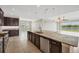 Gourmet kitchen boasts granite counters, stainless steel appliances, and an expansive island at 815 Rosemary Cir, Bradenton, FL 34212
