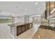 Open-concept kitchen features an island, stainless steel appliances, and seamless flow into the living spaces, all with lake views at 815 Rosemary Cir, Bradenton, FL 34212