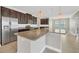 Modern kitchen with granite countertops, stainless steel appliances, and stylish pendant lights at 815 Rosemary Cir, Bradenton, FL 34212