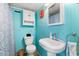 Cozy bathroom with bright blue walls, shower with curtain, and stylish floral accents at 818 50Th Avenue W Ter, Bradenton, FL 34207