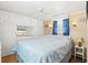 Bright bedroom features built in storage, ceiling fan, and a charming blue and white bedspread at 818 50Th Avenue W Ter, Bradenton, FL 34207