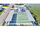 Overhead view of community shuffleboard courts and the adjacent swimming pool by the lake at 818 50Th Avenue W Ter, Bradenton, FL 34207