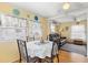 Bright dining area featuring a table with seating for four and living space with a leather sofa at 818 50Th Avenue W Ter, Bradenton, FL 34207