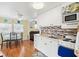 Bright kitchen with white cabinets, modern appliances, and adjacent dining area creates a warm, inviting space at 818 50Th Avenue W Ter, Bradenton, FL 34207