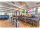 Interior of clubhouse restaurant with bar, tables, and multiple televisions at 8380 Jesolo Ln, Sarasota, FL 34238