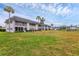 Low rise condo building surrounded by manicured lawn and palm trees at 102 46Th Avenue W Ter # 402, Bradenton, FL 34207