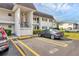 Close up of a condo building with dedicated parking spots at 102 46Th Avenue W Ter # 402, Bradenton, FL 34207