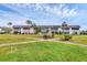 Spacious condo building featuring well-kept lawns and tropical palm trees at 102 46Th Avenue W Ter # 402, Bradenton, FL 34207