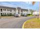 Exterior view of a two-story condo building with ample parking at 102 46Th Avenue W Ter # 402, Bradenton, FL 34207