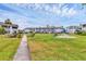 Well-maintained condo complex with lush green lawns and mature landscaping at 102 46Th Avenue W Ter # 402, Bradenton, FL 34207
