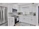 Bright kitchen with white cabinets, quartz countertops, and modern appliances at 102 46Th Avenue W Ter # 402, Bradenton, FL 34207