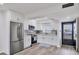 Modern white kitchen featuring stainless steel appliances and wood look floors at 102 46Th Avenue W Ter # 402, Bradenton, FL 34207