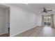 Living room with wood floors, sliding glass doors, fan, and view of a balcony at 102 46Th Avenue W Ter # 402, Bradenton, FL 34207
