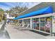 Community pool house area features lounge chairs and stylish blue awning at 102 46Th Avenue W Ter # 402, Bradenton, FL 34207