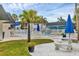 Community pool with tables and chairs and beautiful landscaping at 102 46Th Avenue W Ter # 402, Bradenton, FL 34207