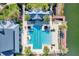 Aerial view of the community pool with palm trees and the lake right off the dock at 12026 Perennial Pl, Bradenton, FL 34211