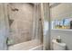 Bright bathroom featuring a tub with tiled walls, shower, and a window bringing in natural light at 12026 Perennial Pl, Bradenton, FL 34211
