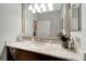 Elegant bathroom featuring a dark vanity with a marble countertop, modern fixtures, and a bright, clean design at 12026 Perennial Pl, Bradenton, FL 34211