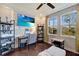 Well-lit bedroom features a ceiling fan, TV, desk, and large windows offering a view of the outdoors at 12026 Perennial Pl, Bradenton, FL 34211