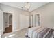Cozy bedroom featuring wood floors, a closet, and a unique lighting fixture at 12026 Perennial Pl, Bradenton, FL 34211