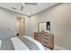 Bright bedroom showcasing a dresser, a modern mirror, and neutral decor, creating a calm and inviting space at 12026 Perennial Pl, Bradenton, FL 34211