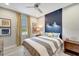 Cozy bedroom with a shiplap accent wall, modern lighting, and a comfortable bed, creating a serene retreat at 12026 Perennial Pl, Bradenton, FL 34211