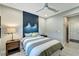 Inviting bedroom featuring a modern accent wall, ambient lighting, and comfortable furnishings at 12026 Perennial Pl, Bradenton, FL 34211