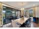 Bright dining room with large windows, a stylish light fixture, and seamless access to an outdoor patio area at 12026 Perennial Pl, Bradenton, FL 34211