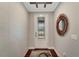 Inviting entryway with decorative mirror, patterned wall, wood floors, and a glass-paneled front door at 12026 Perennial Pl, Bradenton, FL 34211