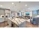 Open-concept kitchen with a granite island, stainless steel appliances, and seamless flow into the living area at 12026 Perennial Pl, Bradenton, FL 34211