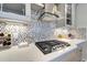 Modern kitchen with stainless steel appliances, tiled backsplash, and sleek range hood, creating a stylish cooking space at 12026 Perennial Pl, Bradenton, FL 34211
