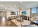 Bright living room with modern furniture, large windows, and a mounted flat-screen TV at 12026 Perennial Pl, Bradenton, FL 34211