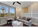 Comfortable room with sofa, ottoman, windows overlooking the lake, and decor at 12026 Perennial Pl, Bradenton, FL 34211