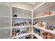 Spacious pantry featuring ample white shelving, perfect for organized storage and easy access to household goods at 12026 Perennial Pl, Bradenton, FL 34211