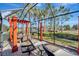 Relaxing patio with seating, pergola, and scenic lake view at 12026 Perennial Pl, Bradenton, FL 34211